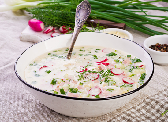 Okroshka-cold-soup-with-fresh-cucumbers-radishes-potato-and-sausage-with-yoghurt-in-bowl
