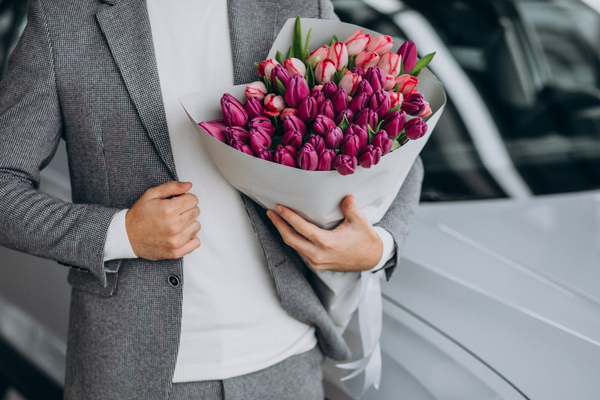 Business-man-delivering-bouquet-flowers
